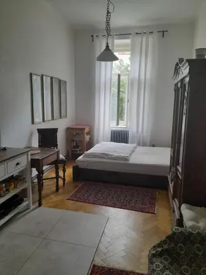 a bedroom with a bed and a desk and a window at Newly Refurbished Self-contained Cosy Room in Prague