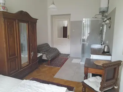 a living room with a bed and a refrigerator at Newly Refurbished Self-contained Cosy Room in Prague