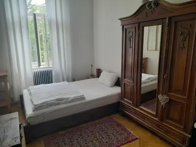 a bedroom with a bed and a dresser and a mirror at Newly Refurbished Self-contained Cosy Room in Prague