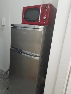 a microwave sitting on top of a refrigerator at Newly Refurbished Self-contained Cosy Room in Prague