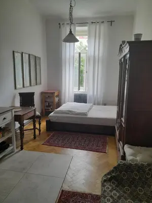 a bedroom with a bed and a desk and a window at Newly Refurbished Self-contained Cosy Room in Prague