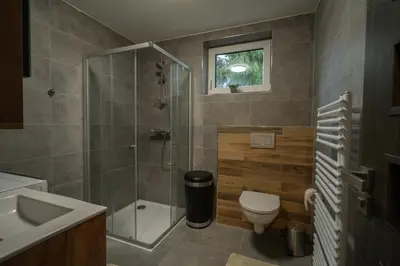 a bathroom with a shower and a toilet and a sink at VH - Apartments