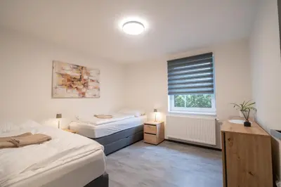 a bedroom with two beds and a window at VH - Apartments