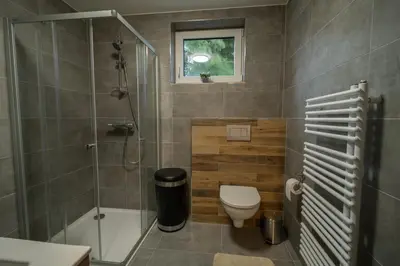 a bathroom with a toilet and a glass shower at VH - Apartments
