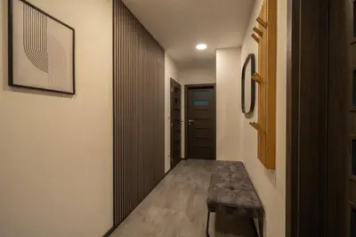 a hallway with a bench and a door at VH - Apartments