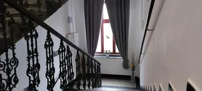 a hallway with a stairway with a window at Soukromé křídlo pro 7 osob v Praze in Prague