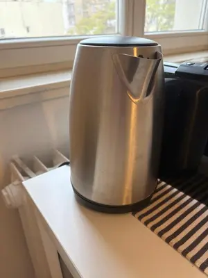 a metal appliance sitting on a counter next to a window at A beautiful cozy room in Prague in Prague