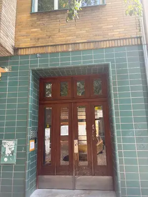a blue tiled building with a wooden door at A beautiful cozy room in Prague in Prague