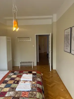 a bedroom with a bed with a quilt on it at A beautiful cozy room in Prague in Prague