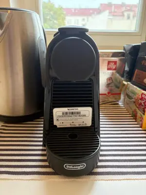 a black toaster sitting on top of a table at A beautiful cozy room in Prague in Prague