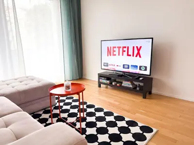 a living room with a couch and a television at New Modern Apartment in Center with Terrace and Parking in Prague