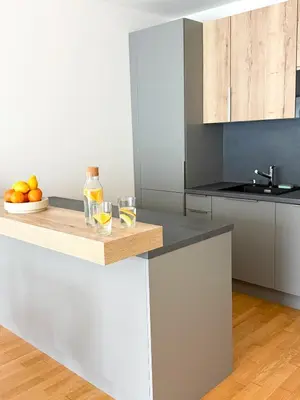 a kitchen with a counter with a bowl of oranges at New Modern Apartment in Center with Terrace and Parking in Prague