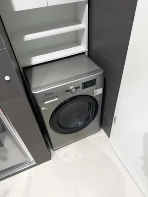 a washer and dryer in a small room at New Modern Apartment in Center with Terrace and Parking in Prague