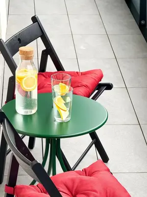 a green table with a bottle and a glass of lemonade at New Modern Apartment in Center with Terrace and Parking in Prague