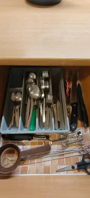 a drawer filled with lots of knives and utensils at Apartmán v Královském Údolí s předzahrádkou in Králŭv Dvŭr