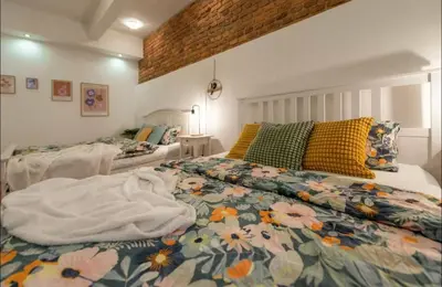 a bedroom with a bed with a floral comforter at Friendly Stay in Prague