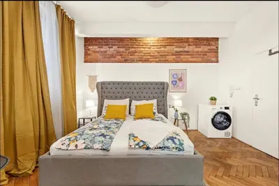 a bedroom with a bed with yellow pillows at Friendly Stay in Prague