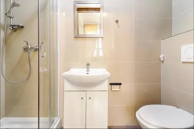 a bathroom with a toilet and a sink and a shower at Friendly Stay in Prague