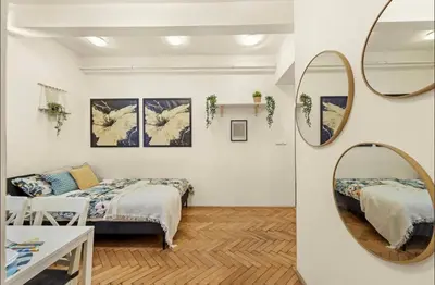 a bedroom with a bed and a mirror at Friendly Stay in Prague