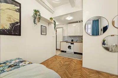 a room with a bed and a kitchen at Friendly Stay in Prague