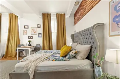 a bedroom with a large bed and a desk at Friendly Stay in Prague