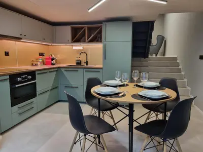a kitchen and dining room with a table and chairs at Beautiful Duplex 20 min from center in Prague