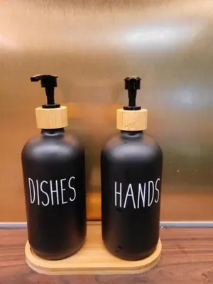 two black bottles with the words dishes and hands on them at Beautiful Duplex 20 min from center in Prague