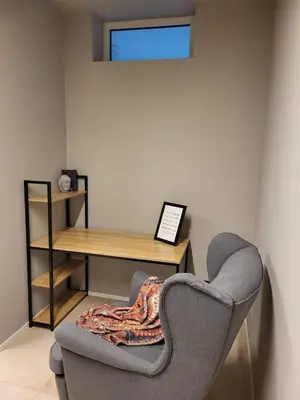 a room with a desk and a chair with a blanket at Beautiful Duplex 20 min from center in Prague