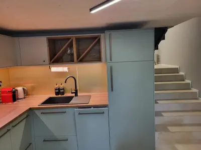 a kitchen with a sink and a staircase at Beautiful Duplex 20 min from center in Prague