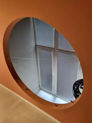 a circular window in a room with a white wall at Beautiful Duplex 20 min from center in Prague