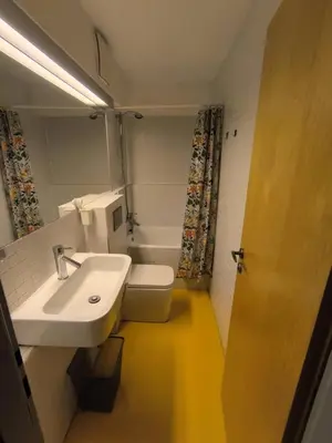 a bathroom with a white sink and a toilet at Loft Palmovka in Prague