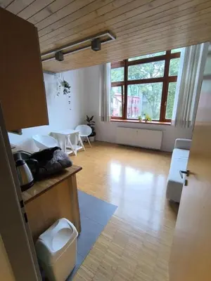 a large room with a kitchen and a dining room at Loft Palmovka in Prague