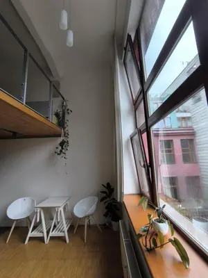 a room with a table and chairs and a window at Loft Palmovka in Prague