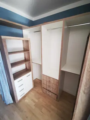 a bedroom with white closets with blue walls and wood floors at Free Parking Modern Smíchov Apartment With Large Balcony in Prague