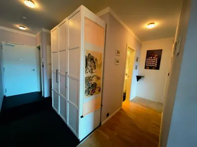 a hallway with white walls and a door to a room at Free Parking Modern Smíchov Apartment With Large Balcony in Prague