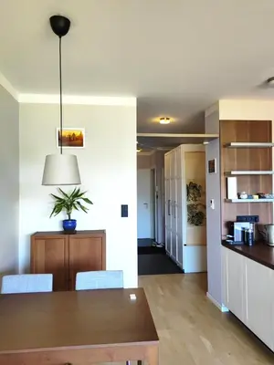 a kitchen and dining room with a table and chairs at Free Parking Modern Smíchov Apartment With Large Balcony in Prague