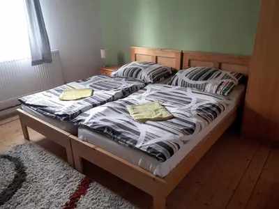 a bed with two pillows on it in a bedroom at Penzion Na Střelnici in Poděbrady