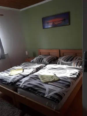 two twin beds in a bedroom with a picture on the wall at Penzion Na Střelnici in Poděbrady