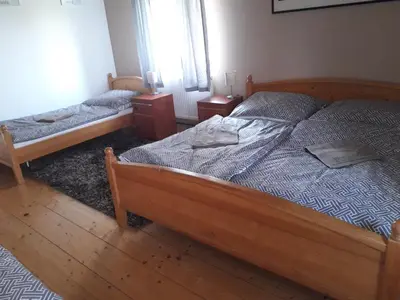 a bedroom with two beds and two night stands at Penzion Na Střelnici in Poděbrady
