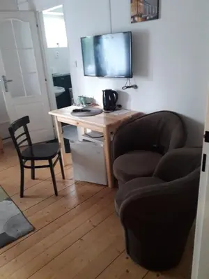 a room with a desk with a computer and a chair at Penzion Na Střelnici in Poděbrady