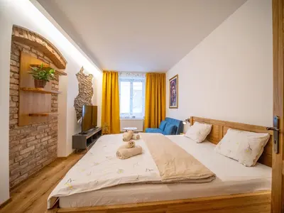 a bedroom with a bed with a teddy bear on it at Apartmán Jimi Hendrix in Nymburk