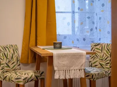 a table with two chairs and a candle on it at Apartmán Jimi Hendrix in Nymburk