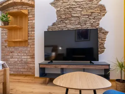a living room with a large flat screen tv at Apartmán Jimi Hendrix in Nymburk