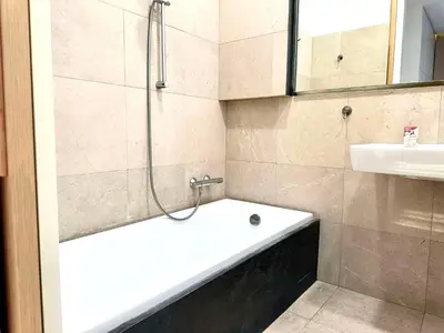 a bathroom with a bath tub and a sink at Awesome Apartment Charles Bridge in Prague