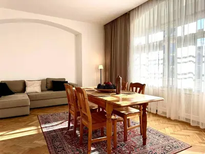 a living room with a wooden table and chairs at Awesome Apartment Charles Bridge in Prague