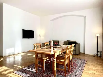 a dining room with a wooden table and chairs at Awesome Apartment Charles Bridge in Prague