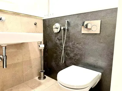 a bathroom with a toilet and a sink at Awesome Apartment Charles Bridge in Prague