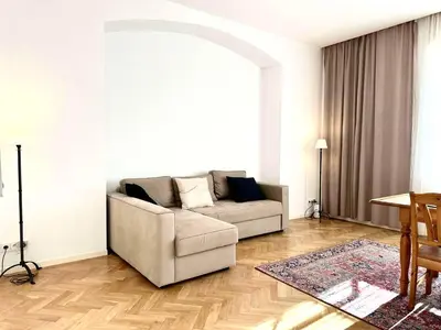 a living room with a couch and a table at Awesome Apartment Charles Bridge in Prague
