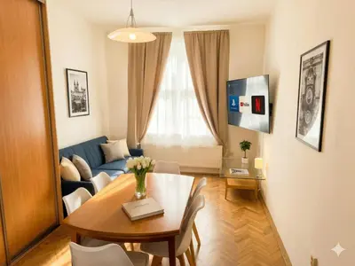 a living room with a red couch and a table at Apartment Paulie 3min to Metro Near O2 Arena and City Centre in Prague