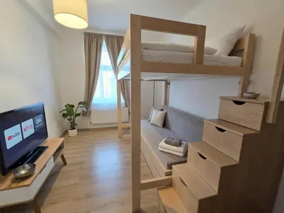 a living room with a television and a table at Apartment Paulie 3min to Metro Near O2 Arena and City Centre in Prague